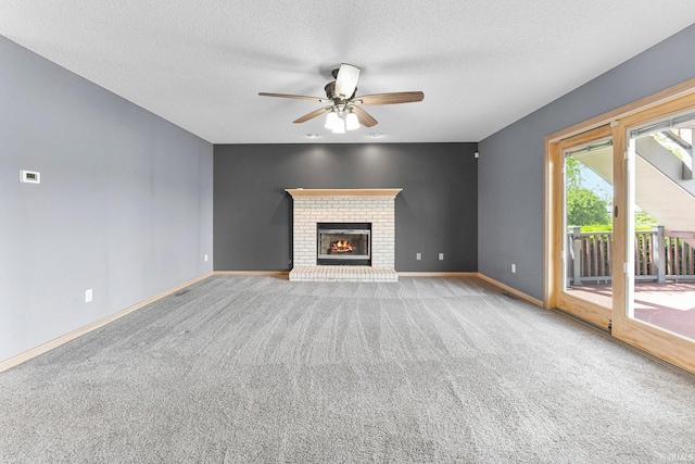 9529 Skipjack Cv, Fort Wayne, IN 46835 - unfurnished living room featuring carpet, a ceiling fan, baseboards, a brick fireplace, and a textured ceiling