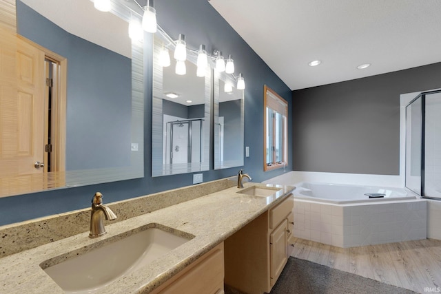 9529 Skipjack Cv, Fort Wayne, IN 46835 - full bathroom with a shower stall, a bath, double vanity, wood finished floors, and recessed lighting