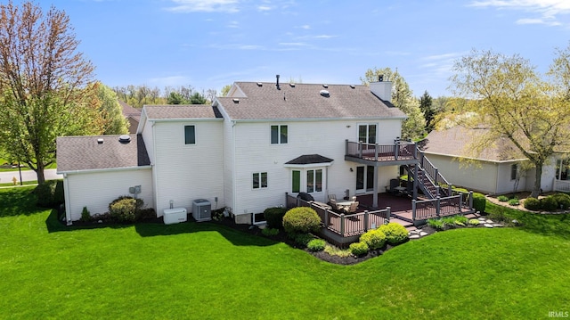 9529 Skipjack Cv, Fort Wayne, IN 46835 - rear view of house with a wooden deck, central AC unit, a chimney, stairs, and a lawn