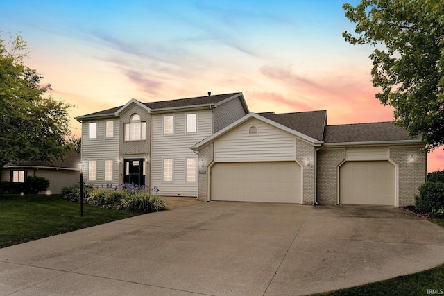 9529 Skipjack Cv, Fort Wayne, IN 46835 - view of front of property with a garage, concrete driveway, a front yard, brick siding, and roof with shingles