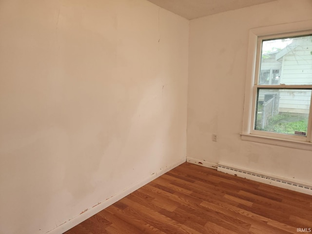 706 S Western Ave, Marion, IN 46952 - spare room with a baseboard heating unit, wood finished floors, and baseboards