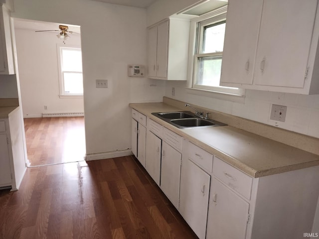 706 S Western Ave, Marion, IN 46952 - kitchen with a sink, a baseboard radiator, ceiling fan, dark wood-style flooring, and white cabinets