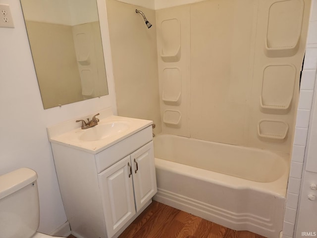 706 S Western Ave, Marion, IN 46952 - bathroom with vanity, wood finished floors, toilet, and tub / shower combination