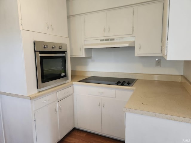 706 S Western Ave, Marion, IN 46952 - kitchen with oven, under cabinet range hood, black electric cooktop, light countertops, and white cabinets