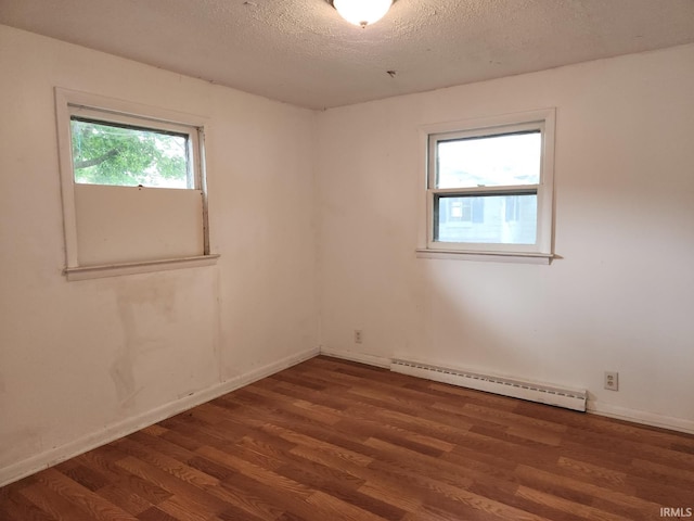 706 S Western Ave, Marion, IN 46952 - unfurnished room with baseboard heating, wood finished floors, a textured ceiling, and baseboards