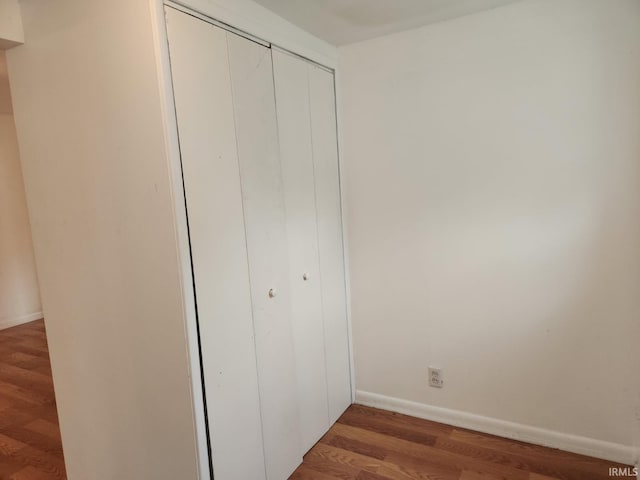 706 S Western Ave, Marion, IN 46952 - unfurnished bedroom with wood finished floors, baseboards, and a closet