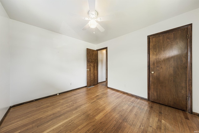 1209 E Water St, Mount Vernon, IN 47620 - unfurnished bedroom featuring hardwood / wood-style floors, baseboards, and a ceiling fan