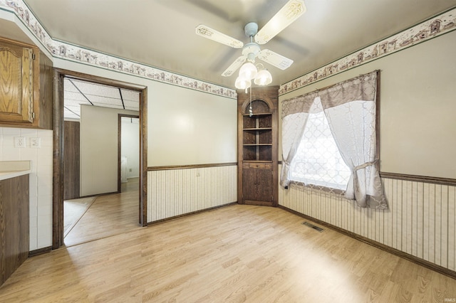 1209 E Water St, Mount Vernon, IN 47620 - unfurnished room featuring light wood-type flooring, wainscoting, and a ceiling fan