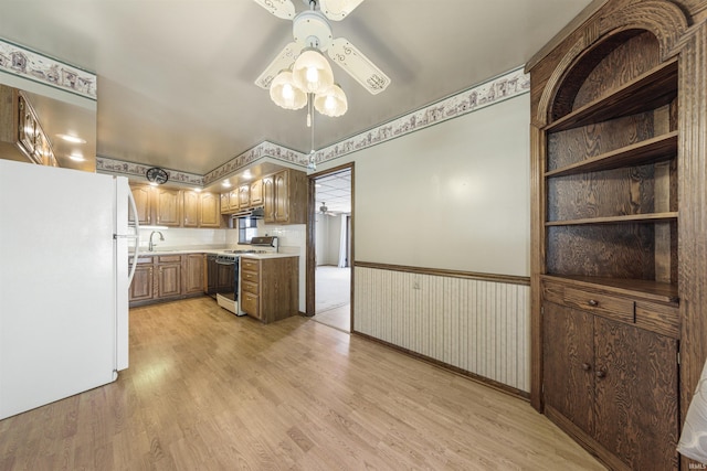 1209 E Water St, Mount Vernon, IN 47620 - kitchen featuring white appliances, a sink, a ceiling fan, light countertops, and light wood-type flooring