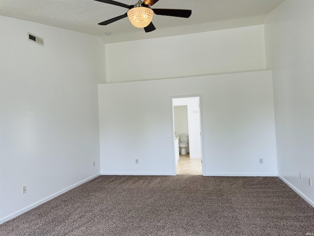 9987 Rainbow Falls Ln, Fishers, IN 46037 - empty room with carpet flooring, ceiling fan, baseboards, and high vaulted ceiling