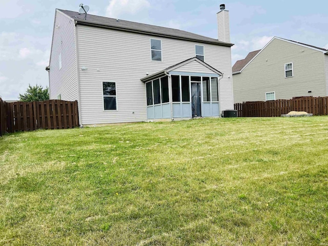 9987 Rainbow Falls Ln, Fishers, IN 46037 - back of property featuring a chimney, a sunroom, and cooling unit