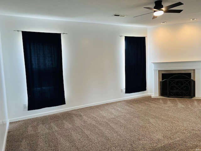 9987 Rainbow Falls Ln, Fishers, IN 46037 - unfurnished living room with carpet floors, a ceiling fan, a tiled fireplace, and baseboards