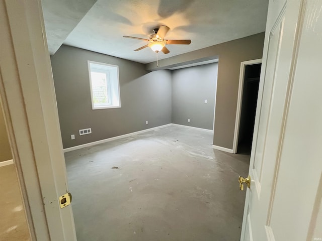 9987 Rainbow Falls Ln, Fishers, IN 46037 - unfurnished bedroom with concrete flooring, baseboards, and a ceiling fan