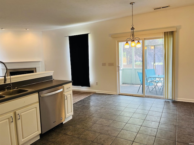 9987 Rainbow Falls Ln, Fishers, IN 46037 - kitchen featuring dishwasher, a sink, dark countertops, decorative light fixtures, and baseboards