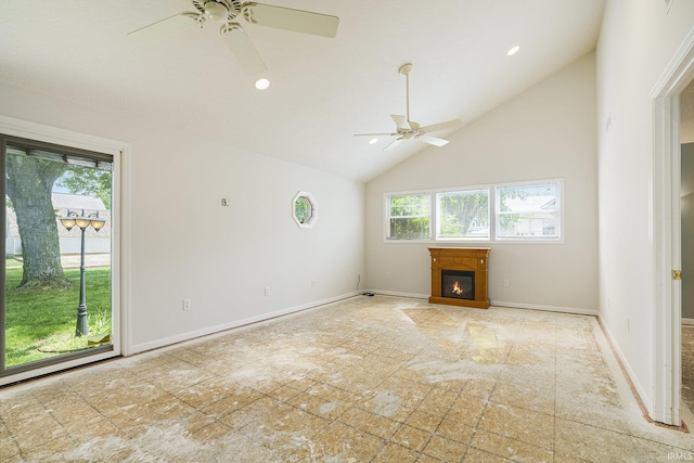 8056 E N Rd, Syracuse, IN 46567 - unfurnished living room with plenty of natural light, a ceiling fan, a glass covered fireplace, baseboards, and high vaulted ceiling