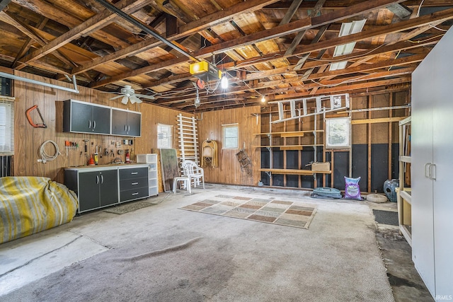 8056 E N Rd, Syracuse, IN 46567 - garage featuring a ceiling fan, wooden walls, and a garage door opener