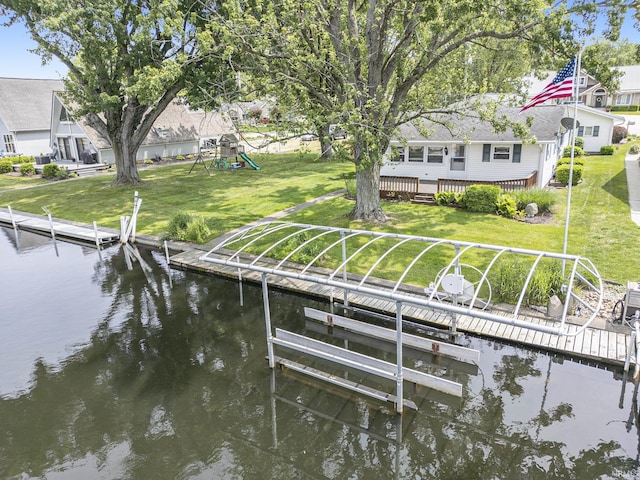 8056 E N Rd, Syracuse, IN 46567 - dock featuring boat lift, a yard, a playground, and a deck with water view