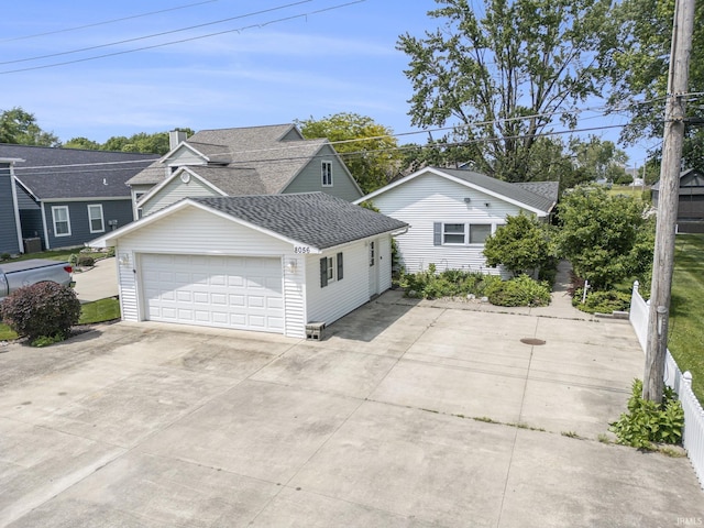 8056 E N Rd, Syracuse, IN 46567 - view of front facade featuring a shingled roof, a garage, and a chimney