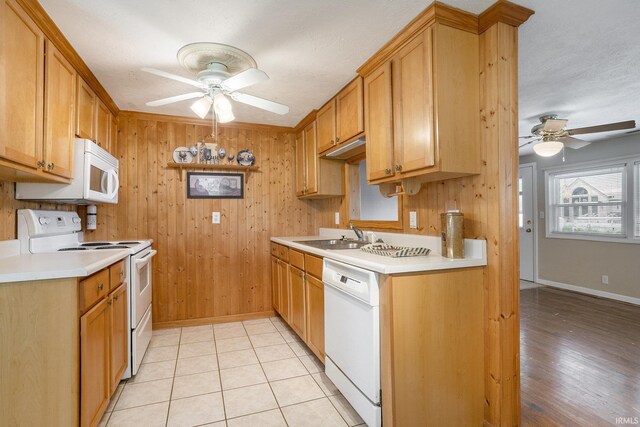 8056 E N Rd, Syracuse, IN 46567 - kitchen featuring white appliances, a ceiling fan, a sink, light countertops, and wooden walls
