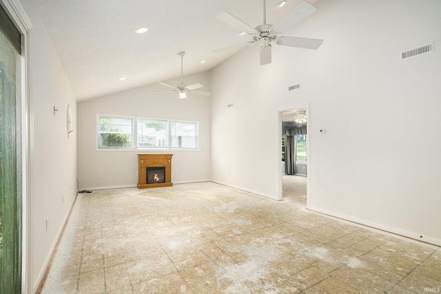 8056 E N Rd, Syracuse, IN 46567 - unfurnished living room with plenty of natural light, a ceiling fan, a glass covered fireplace, high vaulted ceiling, and baseboards