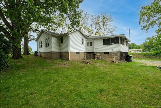 59479 Mayflower Rd, South Bend, IN 46619 - rear view of property featuring a lawn and central AC unit