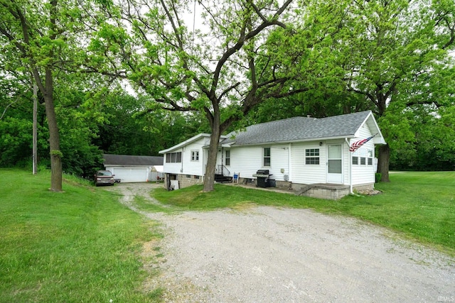 59479 Mayflower Rd, South Bend, IN 46619 - view of front of home with a shingled roof, entry steps, a front lawn, a detached garage, and view of wooded area