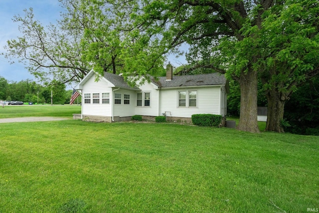 59479 Mayflower Rd, South Bend, IN 46619 - view of front of home featuring a chimney, a front yard, and a shingled roof