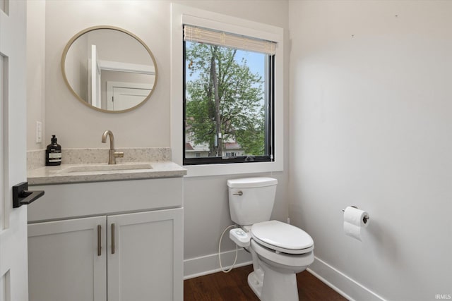 316 S Saint Peter St Unit 7, South Bend, IN 46617 - bathroom with baseboards, toilet, wood finished floors, and vanity