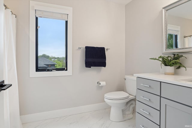 316 S Saint Peter St Unit 7, South Bend, IN 46617 - bathroom with baseboards, marble finish flooring, vanity, and toilet