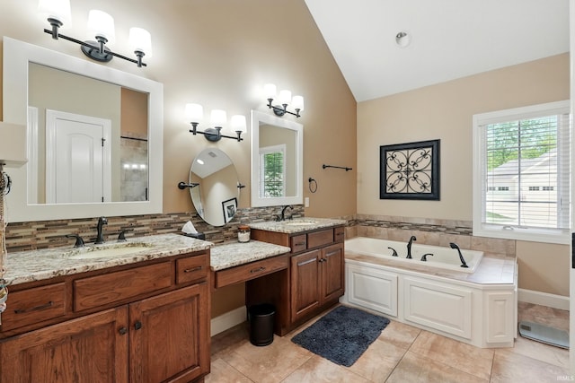 16265 Gemma Pass, Huntertown, IN 46748 - bathroom featuring double vanity, a garden tub, backsplash, tile patterned flooring, and high vaulted ceiling