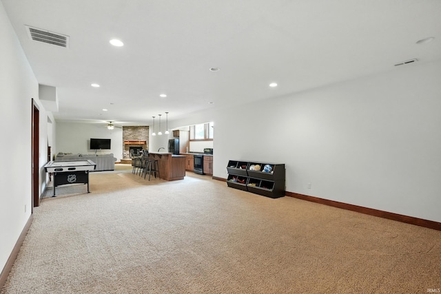 16265 Gemma Pass, Huntertown, IN 46748 - living area featuring light carpet, recessed lighting, baseboards, a fireplace, and beverage cooler