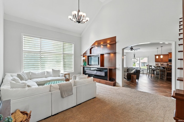 16265 Gemma Pass, Huntertown, IN 46748 - carpeted living area with arched walkways, high vaulted ceiling, a chandelier, tile patterned flooring, and a ceiling fan