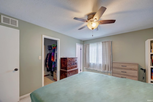 3502 S Tyler Ln, Bloomington, IN 47403 - bedroom with a walk in closet, light colored carpet, baseboards, a closet, and ceiling fan