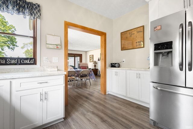 913 Cedar St, Elkhart, IN 46514 - kitchen with stainless steel fridge, wood finished floors, white cabinets, and light stone countertops