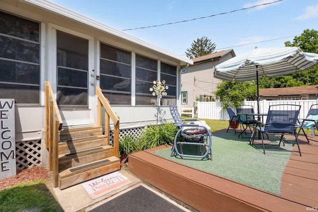 913 Cedar St, Elkhart, IN 46514 - wooden deck featuring entry steps, a sunroom, and outdoor dining area