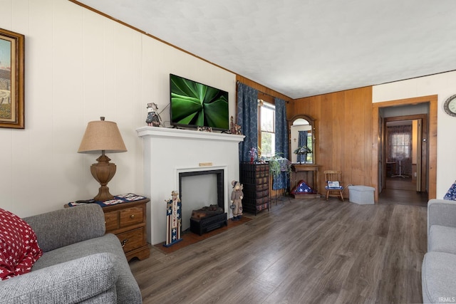 913 Cedar St, Elkhart, IN 46514 - living room with wood finished floors, a fireplace with flush hearth, and wood walls