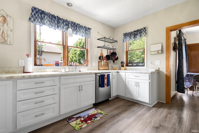 913 Cedar St, Elkhart, IN 46514 - kitchen with dishwasher, a sink, wood finished floors, light countertops, and white cabinets