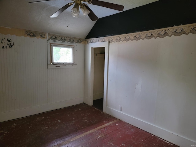 257 Center St, Auburn, IN 46706 - spare room with lofted ceiling, ceiling fan, hardwood / wood-style flooring, and baseboards