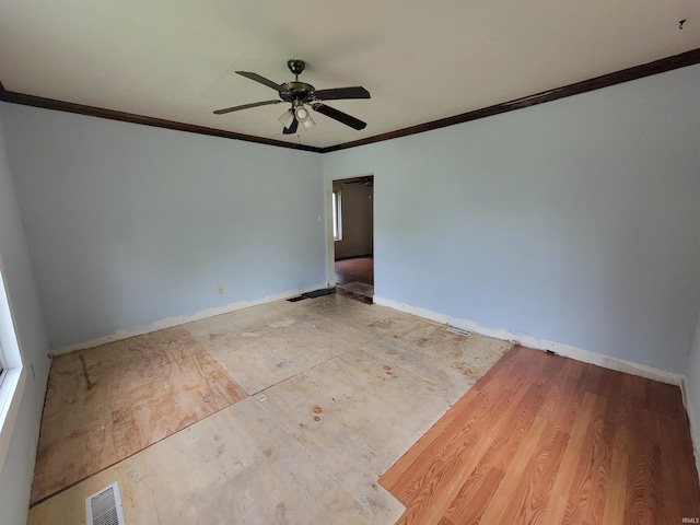 257 Center St, Auburn, IN 46706 - spare room with ornamental molding, a ceiling fan, and baseboards