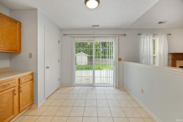 1888 Halyard Ct, West Lafayette, IN 47906 - unfurnished dining area with light tile patterned floors, a textured ceiling, and baseboards