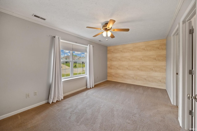 1888 Halyard Ct, West Lafayette, IN 47906 - carpeted spare room featuring wooden walls, a ceiling fan, crown molding, a textured ceiling, and baseboards