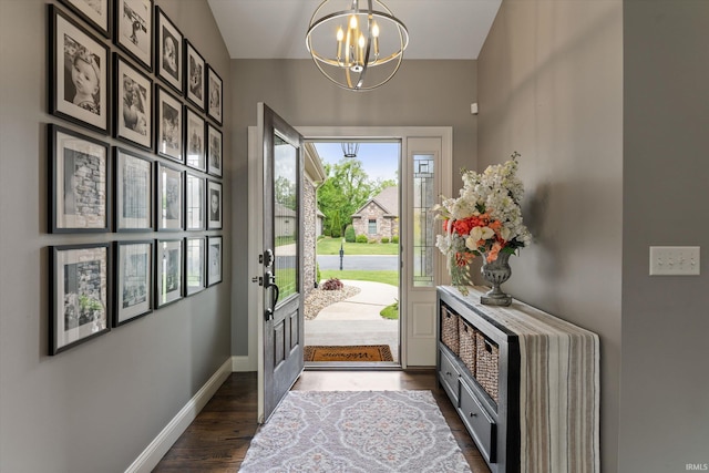 7503 Toscana Ct, Granger, IN 46530 - entryway featuring a chandelier, dark wood-style flooring, and baseboards
