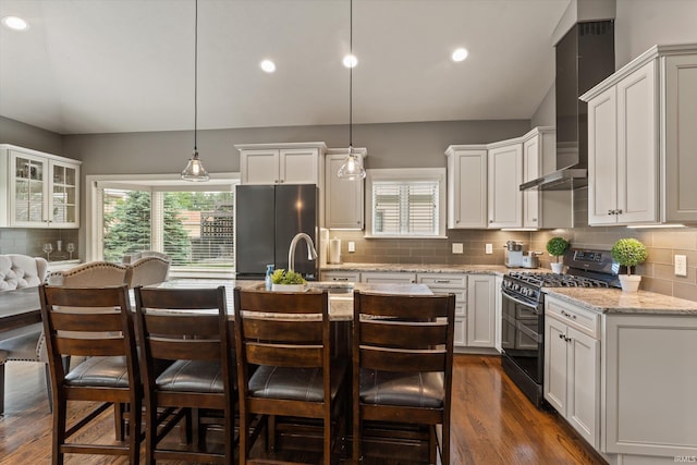 7503 Toscana Ct, Granger, IN 46530 - kitchen featuring range with gas cooktop, freestanding refrigerator, tasteful backsplash, wall chimney exhaust hood, and a sink