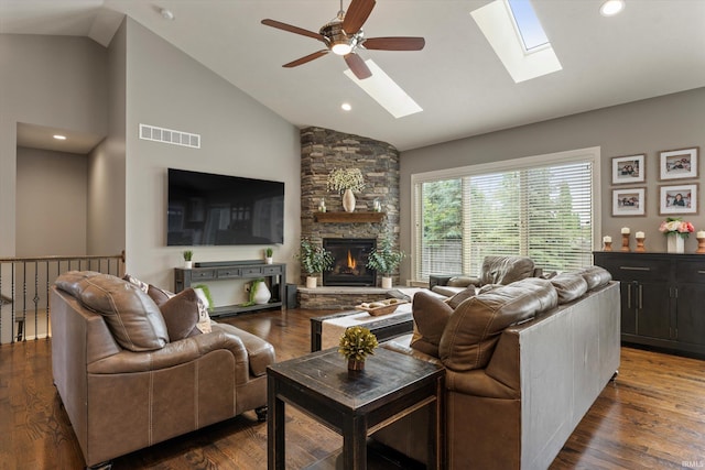 7503 Toscana Ct, Granger, IN 46530 - living room with a skylight, ceiling fan, a stone fireplace, dark wood-style floors, and high vaulted ceiling