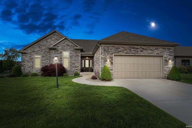 7503 Toscana Ct, Granger, IN 46530 - view of front of house featuring a garage, driveway, a front lawn, a shingled roof, and stone siding