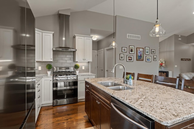 7503 Toscana Ct, Granger, IN 46530 - kitchen featuring a sink, appliances with stainless steel finishes, wall chimney range hood, decorative backsplash, and dark wood-type flooring