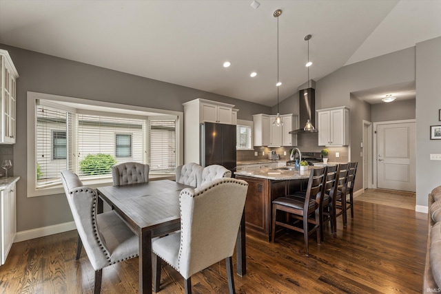 7503 Toscana Ct, Granger, IN 46530 - dining area featuring vaulted ceiling, dark wood-type flooring, baseboards, and recessed lighting