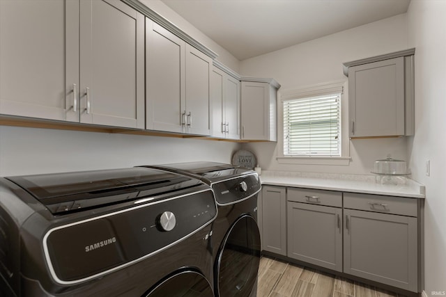 7503 Toscana Ct, Granger, IN 46530 - laundry room featuring independent washer and dryer, cabinet space, and light wood-style floors