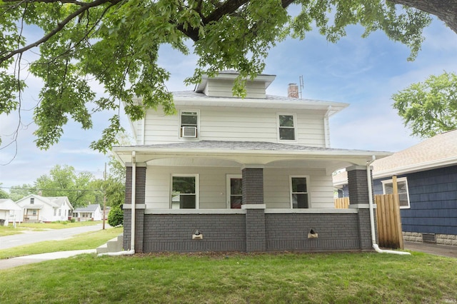 1002 S 33rd St, South Bend, IN 46615 - american foursquare style home featuring a front yard, a chimney, and a porch
