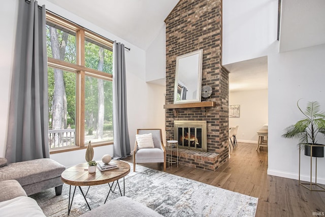 15711 Durham Way, Granger, IN 46530 - living room featuring high vaulted ceiling, hardwood / wood-style flooring, a fireplace, healthy amount of natural light, and baseboards
